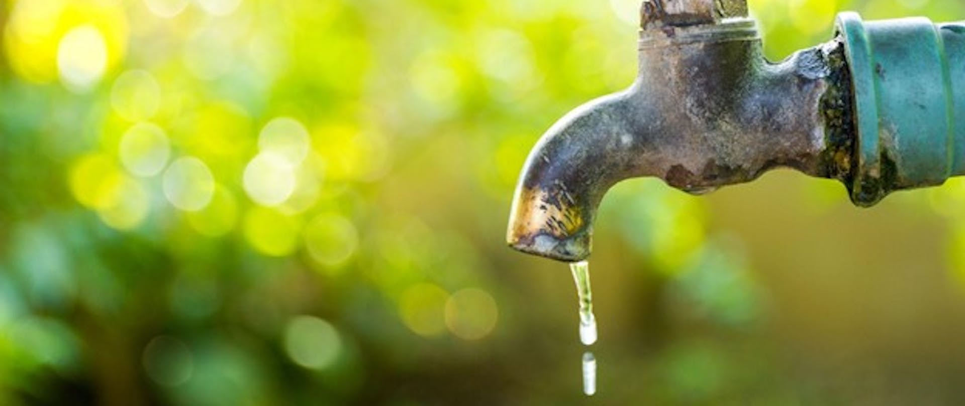 Water Conservation Demonstrated With Leaky Faucet Outdoors