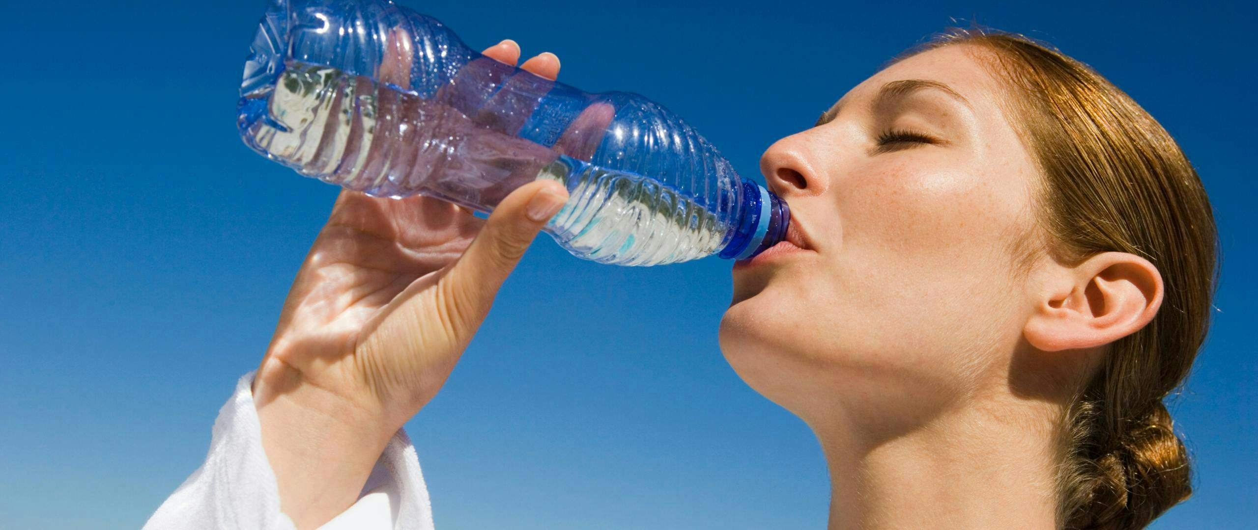 Woman Drinking Bottled Water | Filtered Water Benefits
